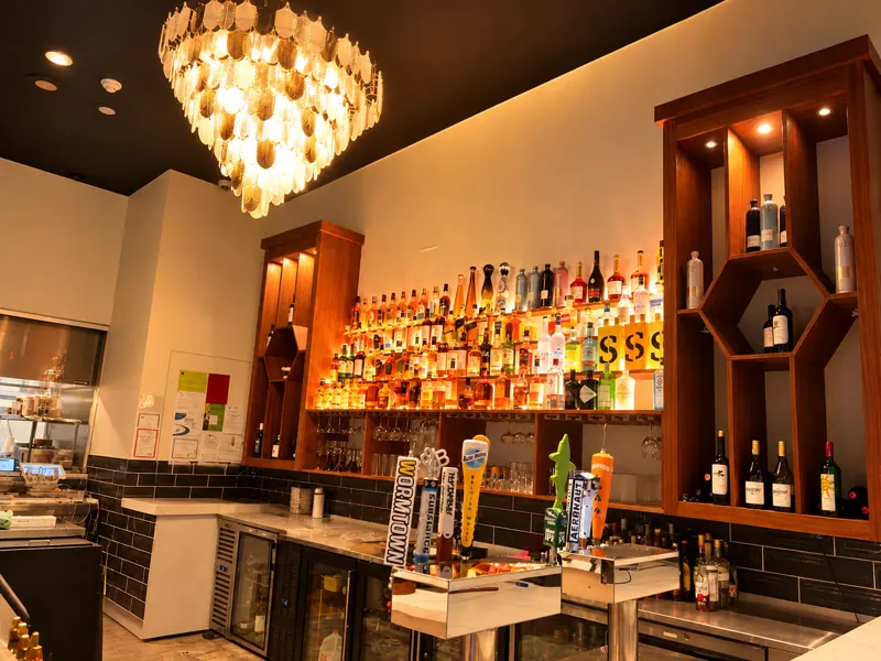 Draft beer taps and the back bar at Rassa